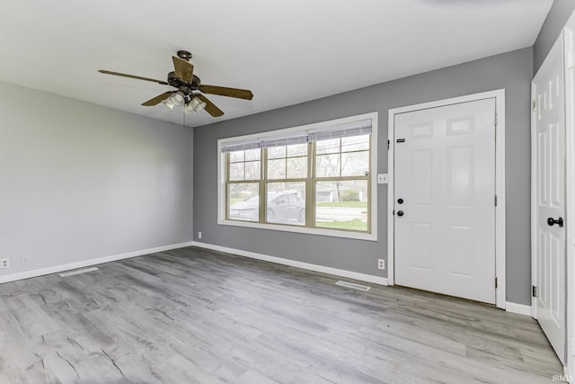 entrance foyer with baseboards and wood finished floors