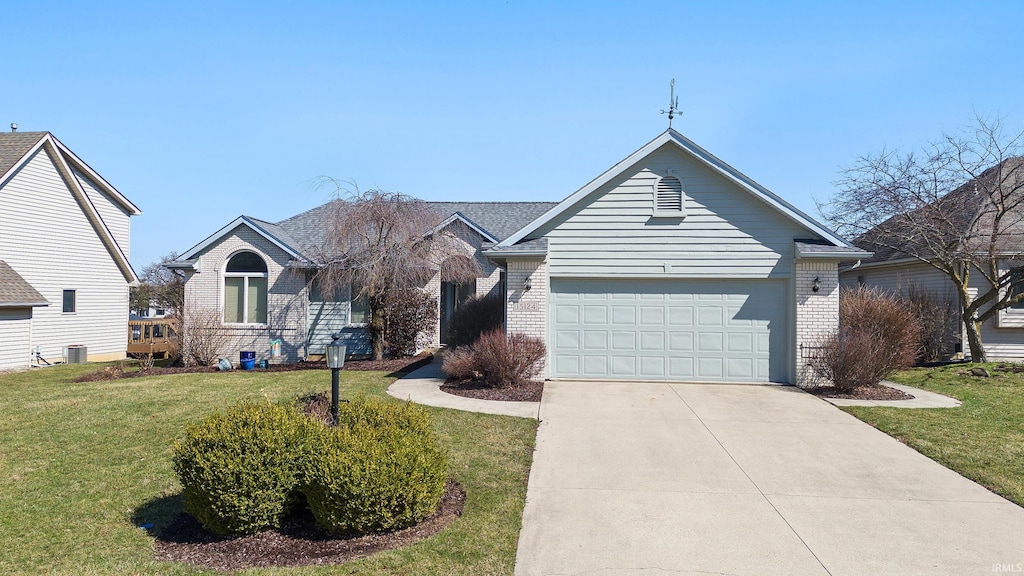 ranch-style house with brick siding, a garage, concrete driveway, and a front yard