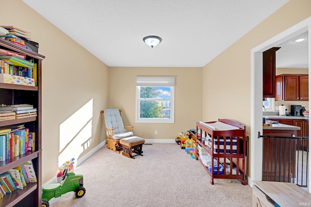 playroom with carpet floors and baseboards