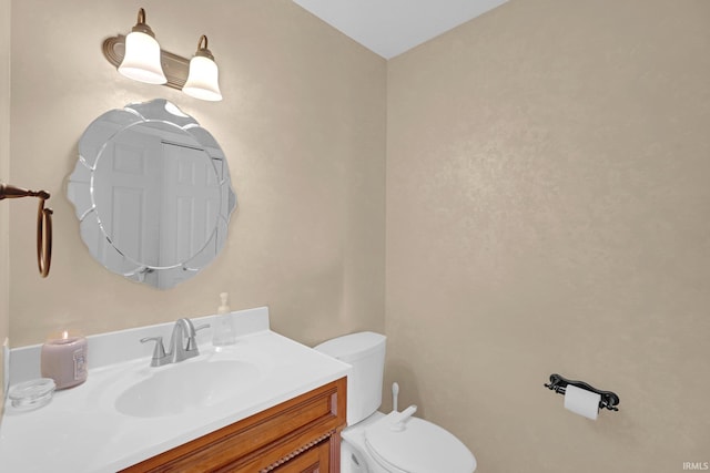 bathroom with toilet and vanity
