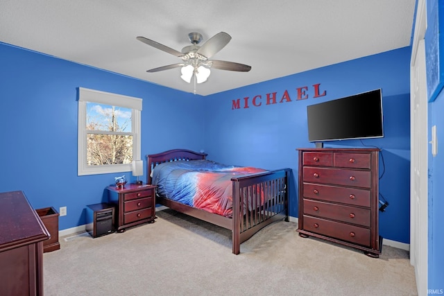 carpeted bedroom with baseboards and ceiling fan
