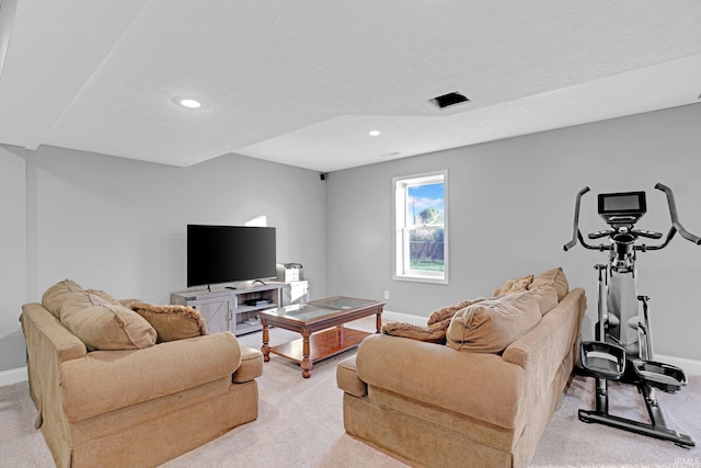 living room with light carpet, a textured ceiling, baseboards, and recessed lighting