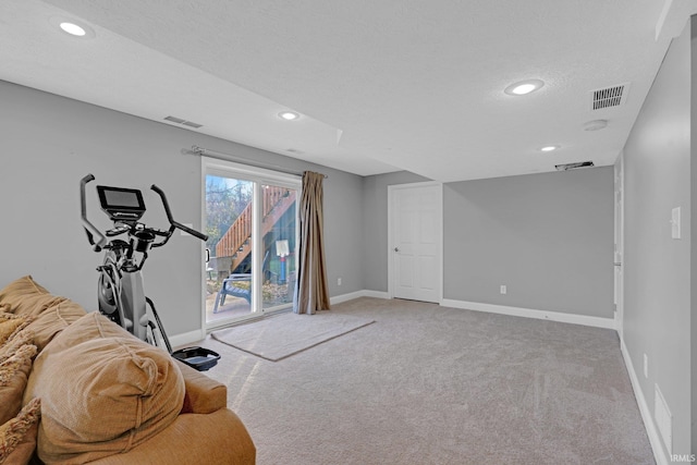 exercise room with carpet flooring, a textured ceiling, baseboards, visible vents, and recessed lighting