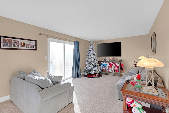 carpeted living room featuring baseboards