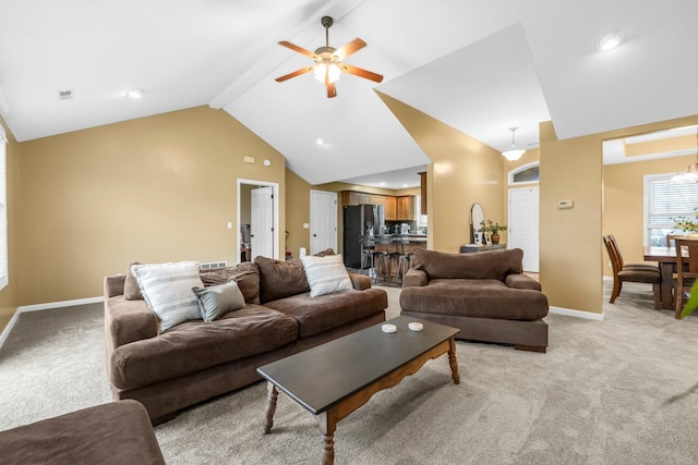 living room with baseboards, visible vents, a ceiling fan, and light colored carpet
