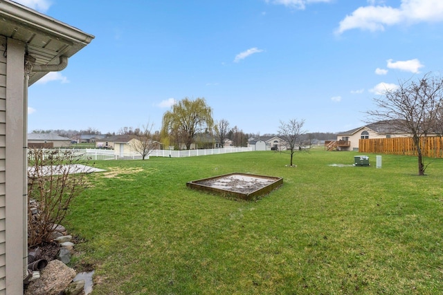 view of yard featuring a fenced backyard and a residential view