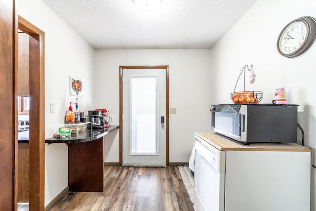 2680 S 390 W, Pleasant Lake, IN 46779 - kitchen featuring a textured ceiling, refrigerator, stainless steel microwave, and wood finished floors
