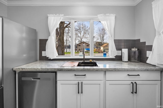 5255 E Bay Front Ct, Monticello, IN 47960 - kitchen with decorative backsplash, crown molding, stainless steel appliances, white cabinetry, and a sink