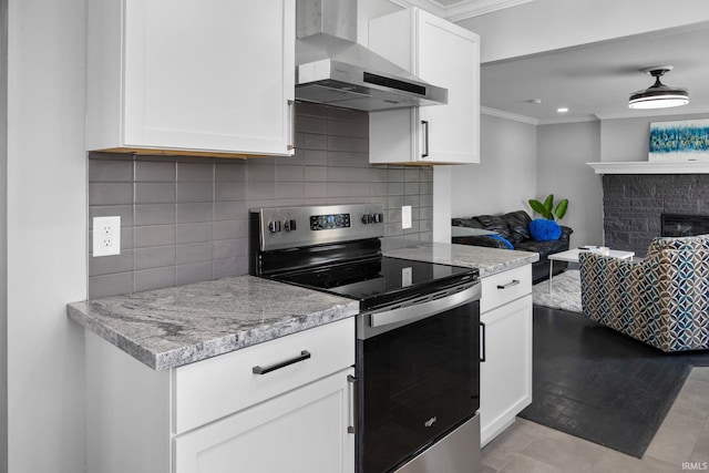 5255 E Bay Front Ct, Monticello, IN 47960 - kitchen with open floor plan, crown molding, stainless steel range with electric stovetop, decorative backsplash, and wall chimney exhaust hood