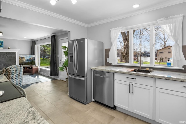 5255 E Bay Front Ct, Monticello, IN 47960 - kitchen with stainless steel appliances, ornamental molding, a sink, white cabinets, and light stone countertops