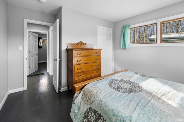 5255 E Bay Front Ct, Monticello, IN 47960 - bedroom featuring baseboards and dark wood-style flooring