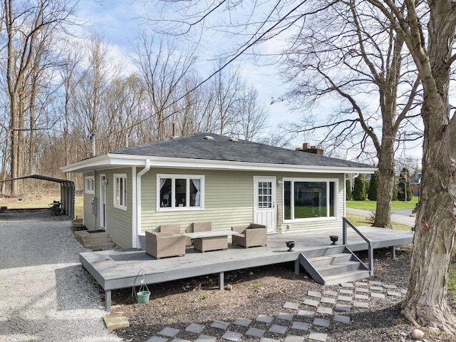 5255 E Bay Front Ct, Monticello, IN 47960 - rear view of house featuring gravel driveway, an outdoor hangout area, a carport, and a deck