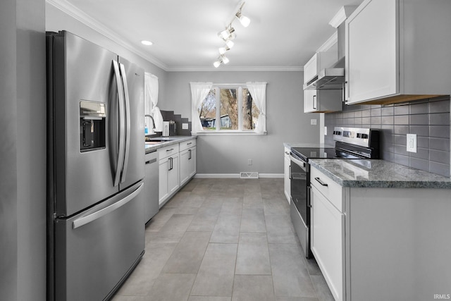 5255 E Bay Front Ct, Monticello, IN 47960 - kitchen featuring white cabinetry, ornamental molding, backsplash, appliances with stainless steel finishes, and wall chimney exhaust hood