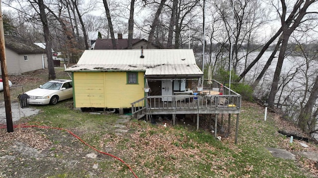 rear view of property with metal roof and a wooden deck