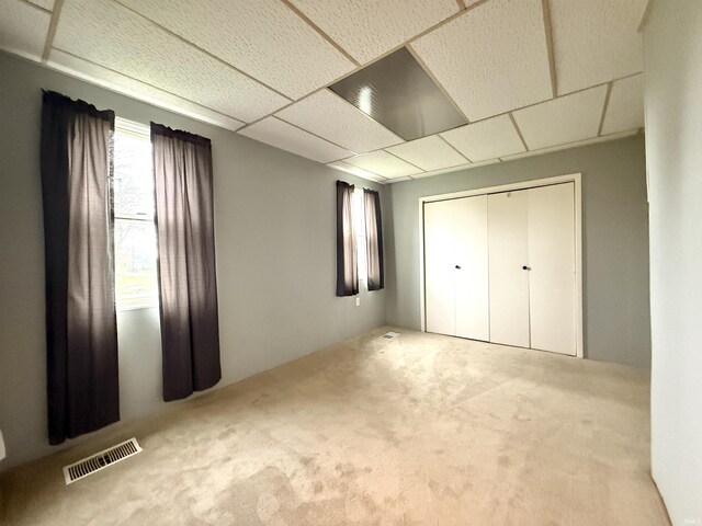 603 N Maple St, Converse, IN 46919 - unfurnished bedroom with a closet, visible vents, a paneled ceiling, and carpet