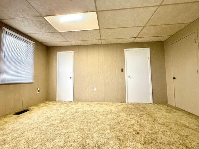 603 N Maple St, Converse, IN 46919 - spare room featuring carpet flooring, visible vents, a drop ceiling, and wooden walls