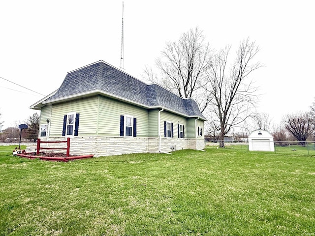 603 N Maple St, Converse, IN 46919 - view of side of home with a lawn, stone siding, mansard roof, and roof with shingles