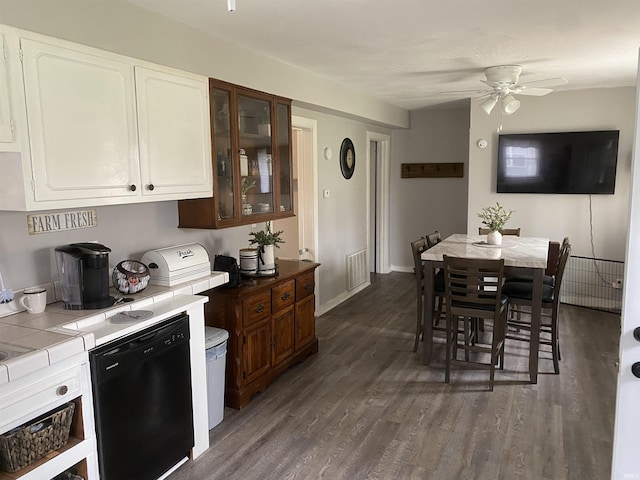 kitchen with dark wood-type flooring, ceiling fan, tile counters, and dishwasher