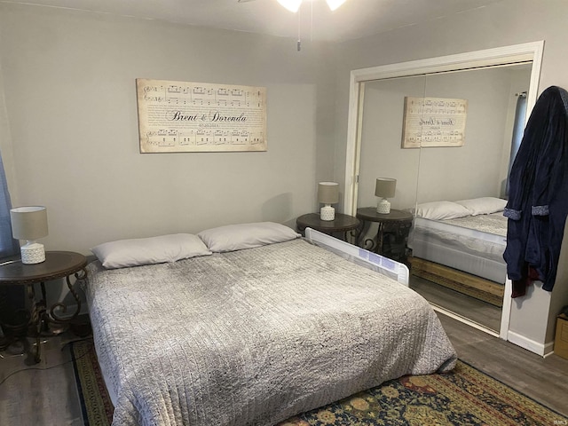 bedroom with a closet, baseboards, and wood finished floors