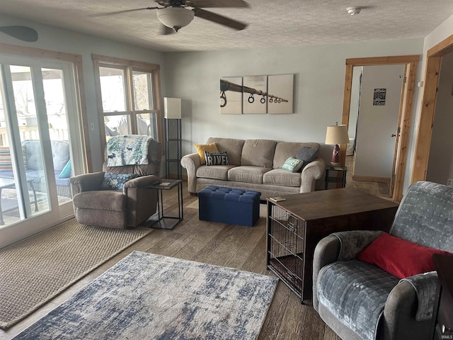 living area featuring a ceiling fan, wood finished floors, and a textured ceiling