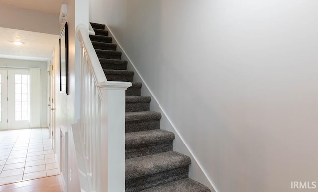 stairway with tile patterned floors