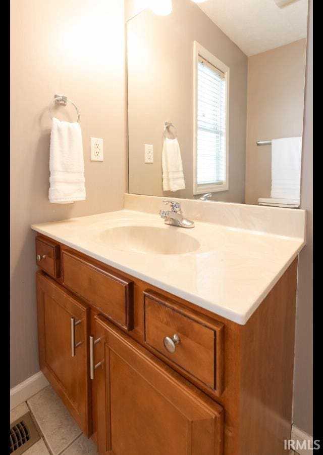 bathroom with tile patterned floors and vanity