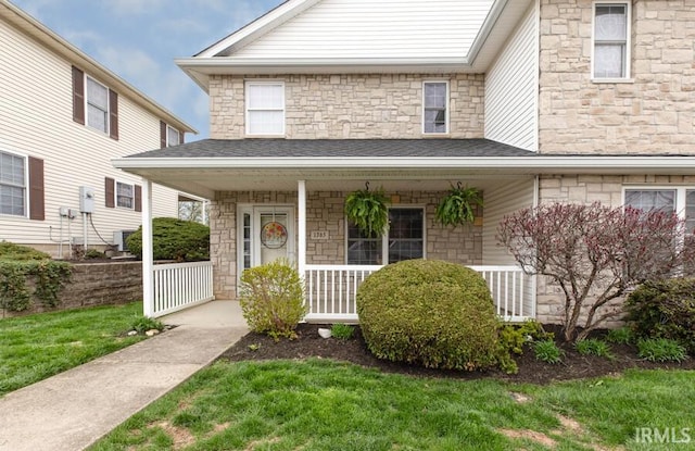 1365 S Stella Dr, Bloomington, IN 47401 - view of front facade with a porch, stone siding, and a front yard