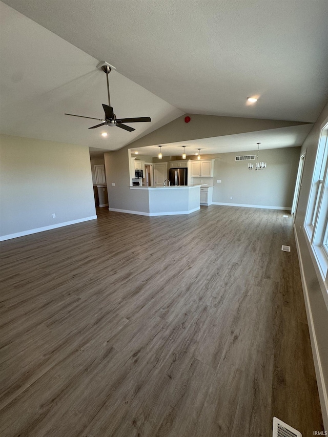 5115 Bankside Ct, Mishawaka, IN 46544 - unfurnished living room with baseboards, dark wood-style floors, lofted ceiling, and ceiling fan