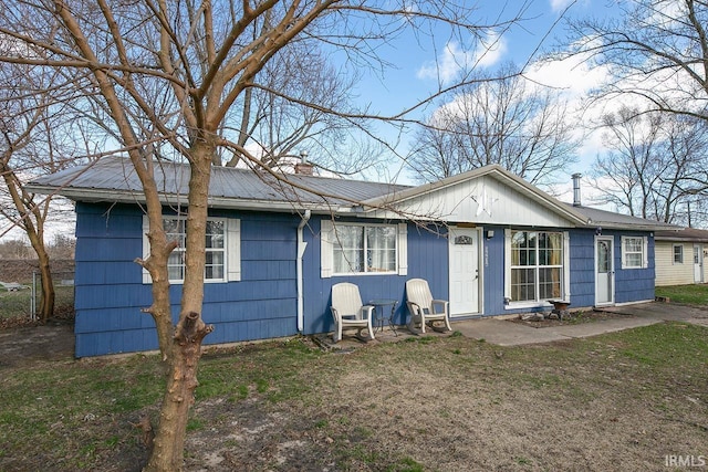 56626 Miller Dr, Elkhart, IN 46516 - view of front facade featuring a front lawn, metal roof, and a chimney