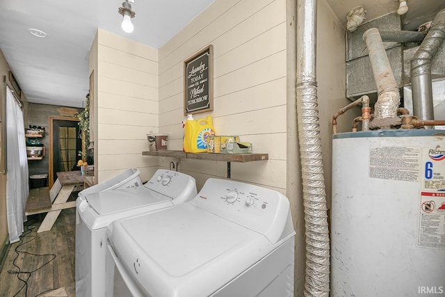 56626 Miller Dr, Elkhart, IN 46516 - clothes washing area featuring wood walls, water heater, washing machine and dryer, and wood finished floors