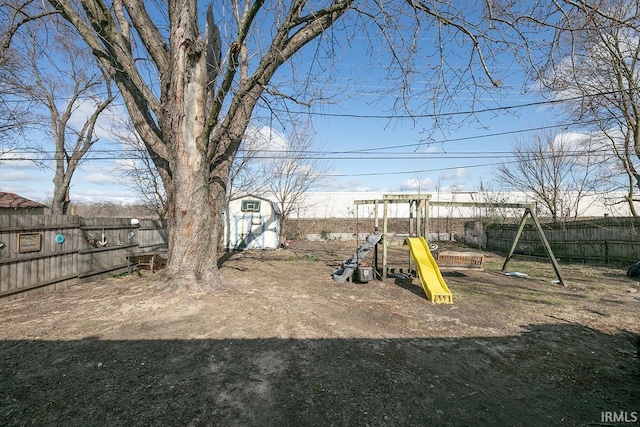 56626 Miller Dr, Elkhart, IN 46516 - view of play area featuring an outbuilding and a fenced backyard