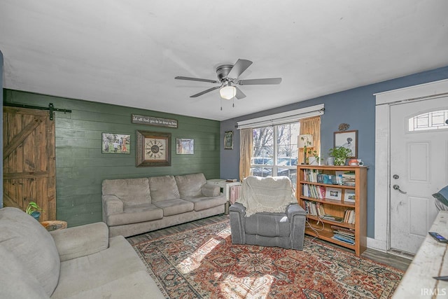 56626 Miller Dr, Elkhart, IN 46516 - living room with wood walls, ceiling fan, a barn door, and wood finished floors