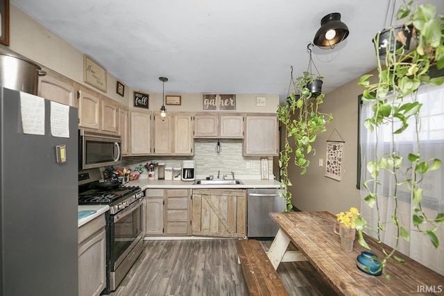 56626 Miller Dr, Elkhart, IN 46516 - kitchen featuring light countertops, decorative backsplash, stainless steel appliances, a sink, and light brown cabinetry