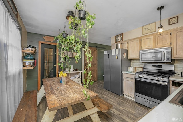 56626 Miller Dr, Elkhart, IN 46516 - kitchen featuring dark wood-type flooring, light countertops, a barn door, and stainless steel appliances