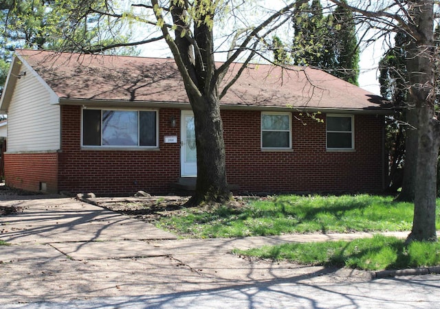 single story home featuring brick siding