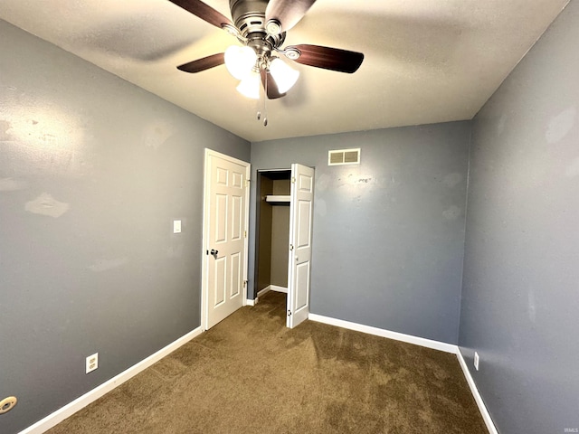 unfurnished bedroom with a closet, baseboards, carpet, and visible vents