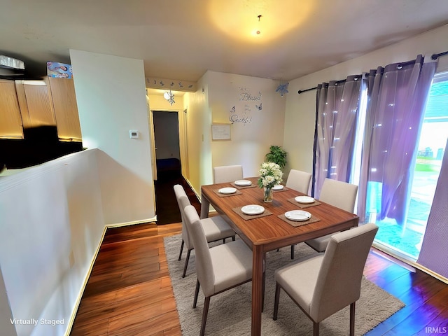 dining space with hardwood / wood-style flooring