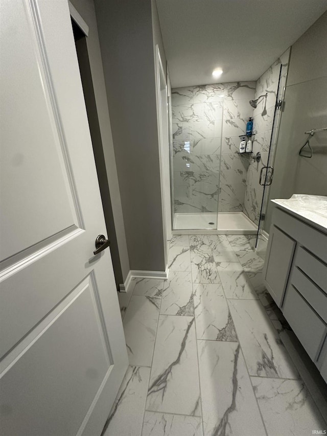 bathroom with vanity, recessed lighting, marble finish floor, a marble finish shower, and baseboards