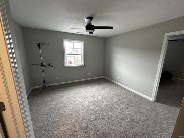 unfurnished bedroom featuring carpet flooring, baseboards, and a ceiling fan