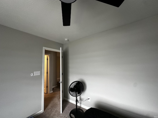 interior space with a textured ceiling, baseboards, and carpet