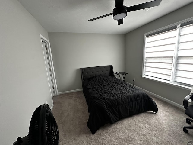 bedroom featuring ceiling fan, carpet flooring, and baseboards