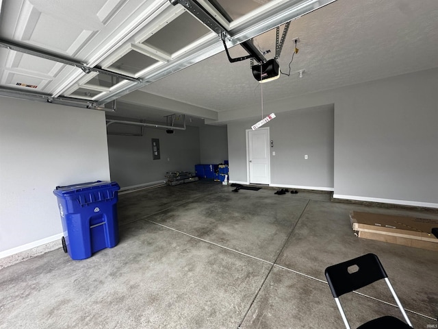 garage featuring baseboards and electric panel