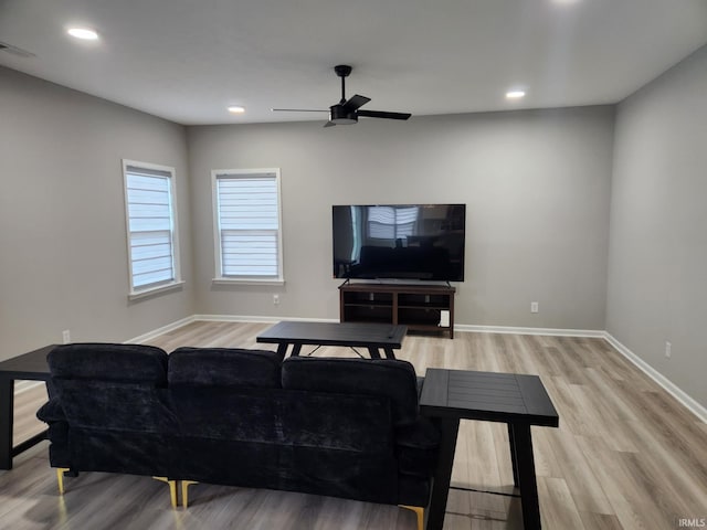 living area featuring light wood-style floors, baseboards, and visible vents