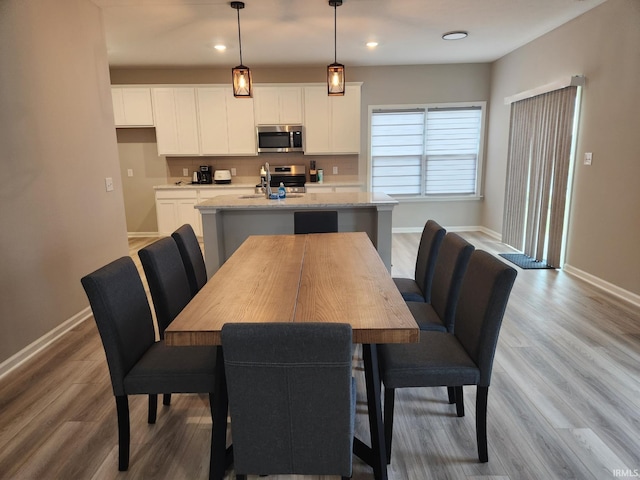 dining area with wood finished floors, baseboards, and recessed lighting