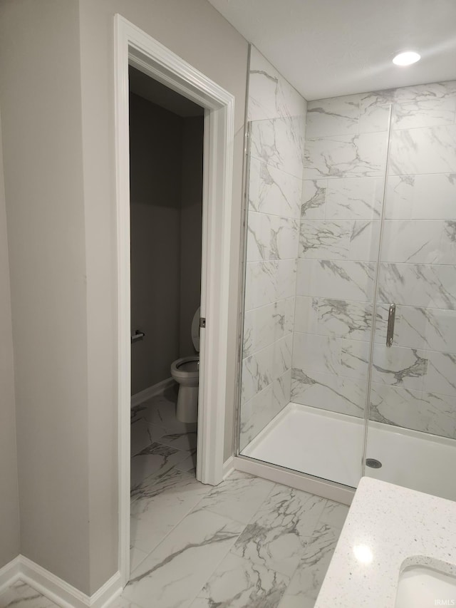 bathroom featuring toilet, marble finish floor, baseboards, and a marble finish shower