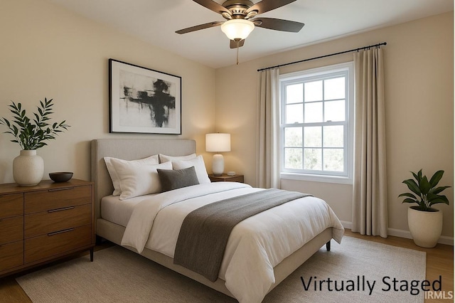 5922 N Ajuga Ct, Ellettsville, IN 47429 - bedroom featuring ceiling fan, light wood-type flooring, and baseboards