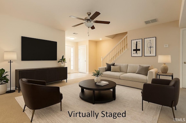 5922 N Ajuga Ct, Ellettsville, IN 47429 - carpeted living room featuring stairs, visible vents, and a ceiling fan