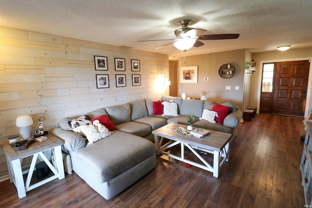 living area featuring hardwood / wood-style flooring, a textured ceiling, and ceiling fan