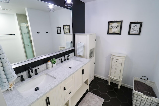 bathroom with a sink, visible vents, a shower stall, and tile patterned flooring