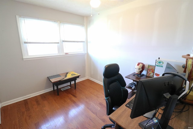 home office with wood finished floors and baseboards